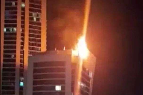 A fire on the top of a building.