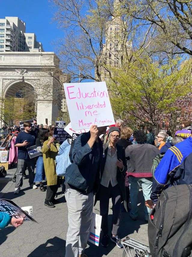 Protestor holding a sign that reads 