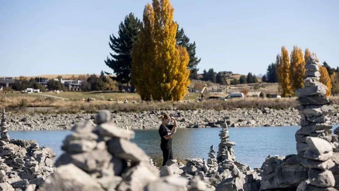 Rock cairns being made by tourists at Tekapo in front of the Church of The Good Shepherd is frustrating some locals. Photo / George Heard