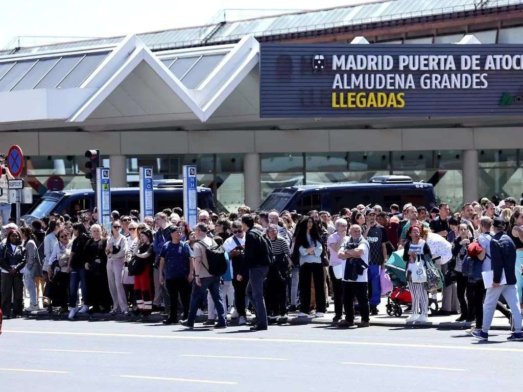 People leave the Atocha train station in Madrid after its closure. Picture: AFP