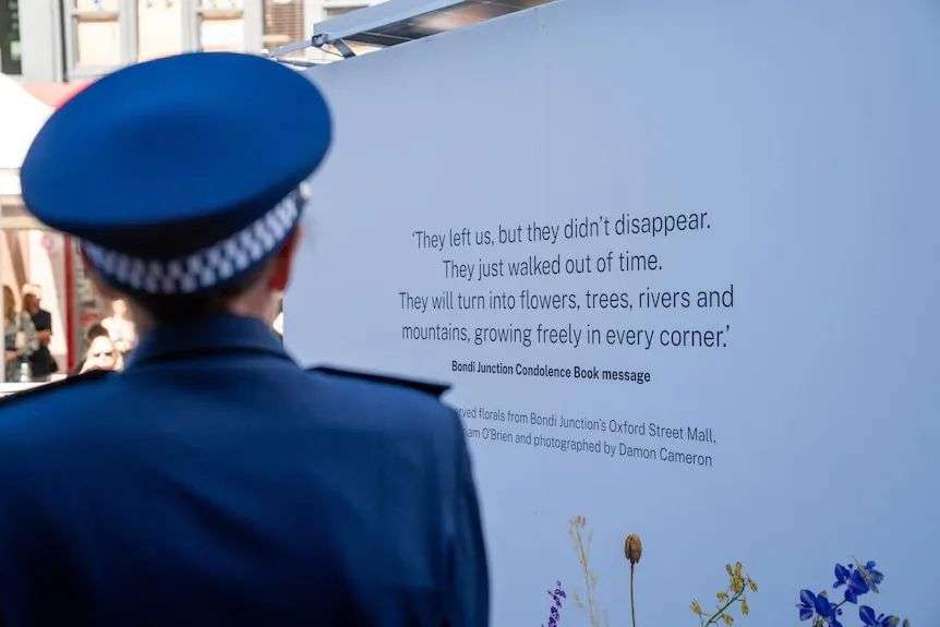the back of NSW Police Commissioner Karen Webb in front of a memorial for bondi stabbing attack victims