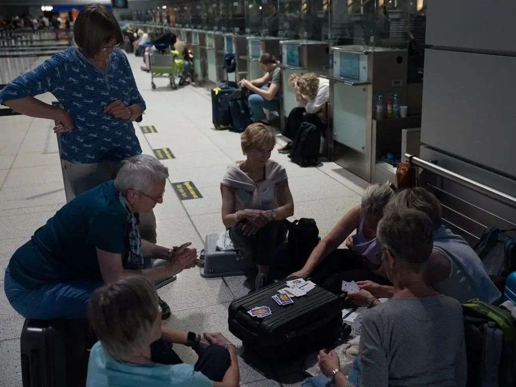 People sit in the airport during the electricity shutdown in Lisbon. Picture: Getty Images