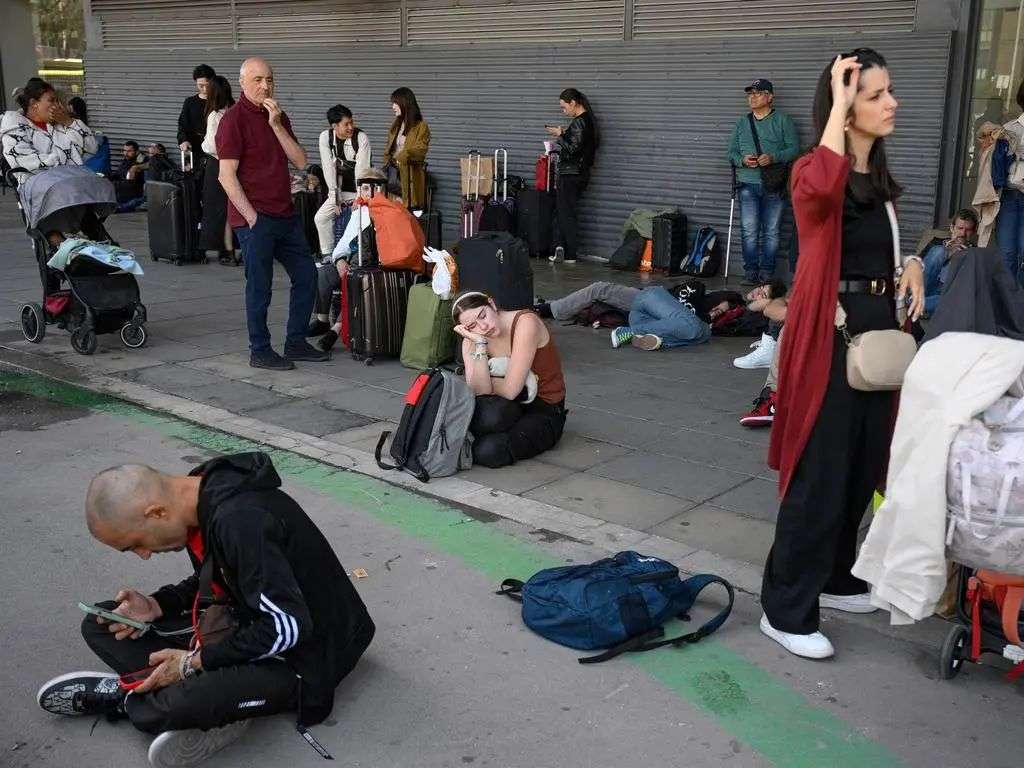 People listen for news on loudspeakers in Barcelona. Picture: AFP
