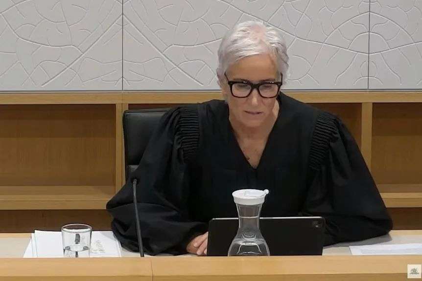 NSW State Coroner Magistrate Teresa O'Sullivan in black robe sits in court bench