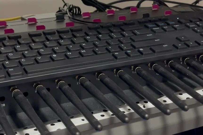 Computer equipment with aerials at the front, keyboard at the top and sim cards at the back.