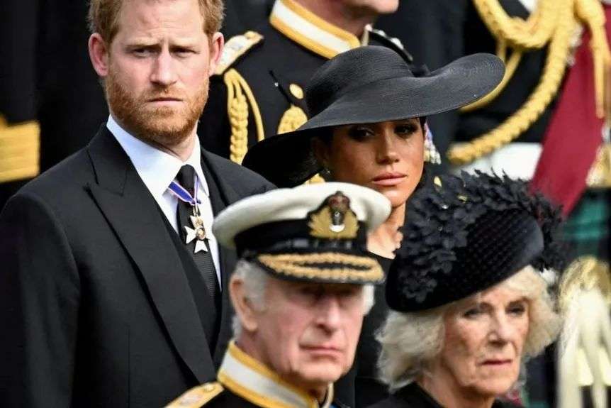 Meghan Markle cries as she stands next to Prince Harry, behind Queen Camilla and King Charles