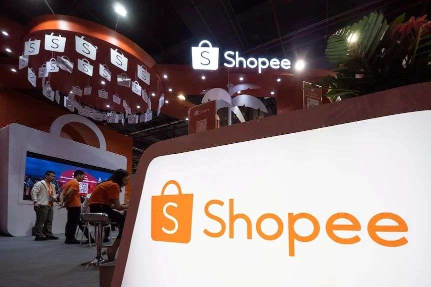 A photo of advertising signs and the Shopee logo at a business expo.