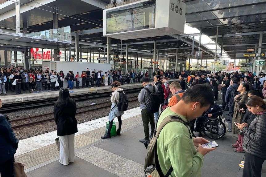 Passengers crowd around waiting at Parramatta train station