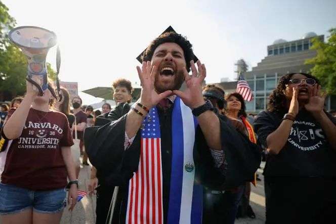 A person wears a stole with the flags of US and El Salvador as members of the Harvard community take part in a 'Harvard Stand United' rally to 'support and celebrate' the school's international students at Harvard University in Cambridge, Massachusetts, May 27, 2025.