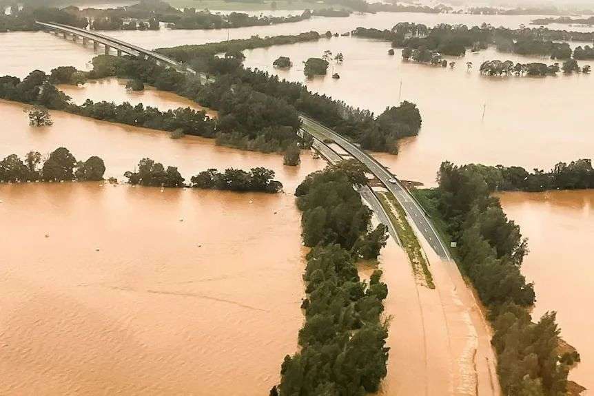 Aerial show of flood water across a highway.