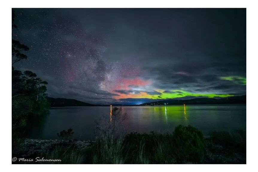 A photo of the the aurora Australis over a body of water