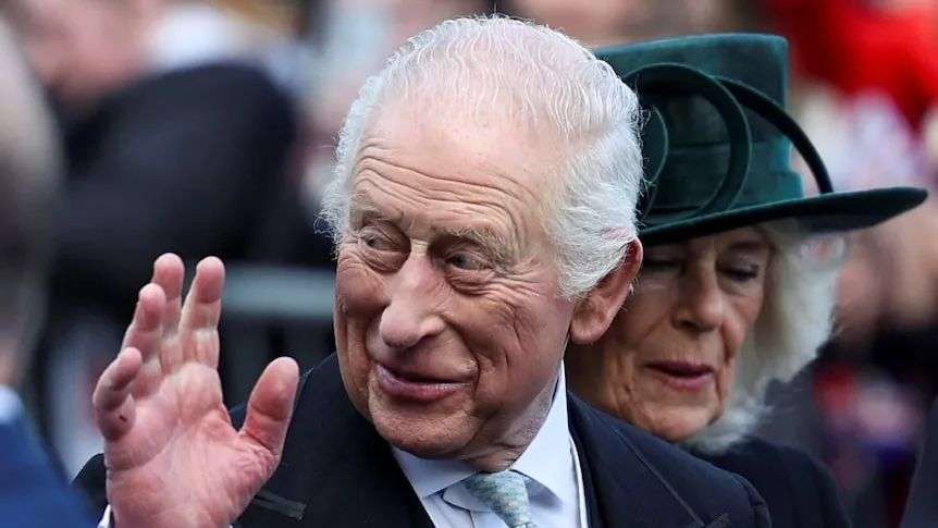 King Charles waving with a smile as he leaves a church service.