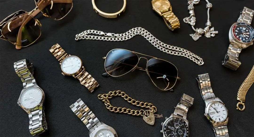 A flat display of watches, sunglasses and bracelets that were left behind at Sydney Airport.