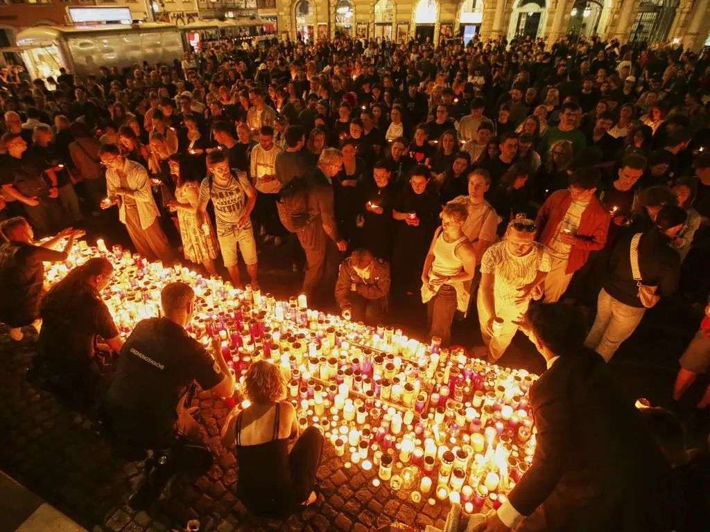 People light candles on the main square in the city centre after the deadly shooting. Pictire: AP