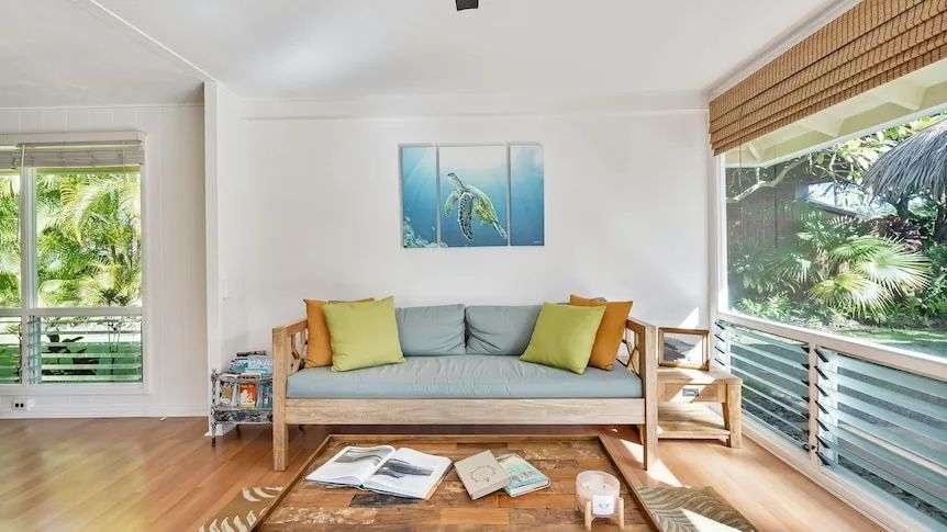 couch in living room with coffee table and window