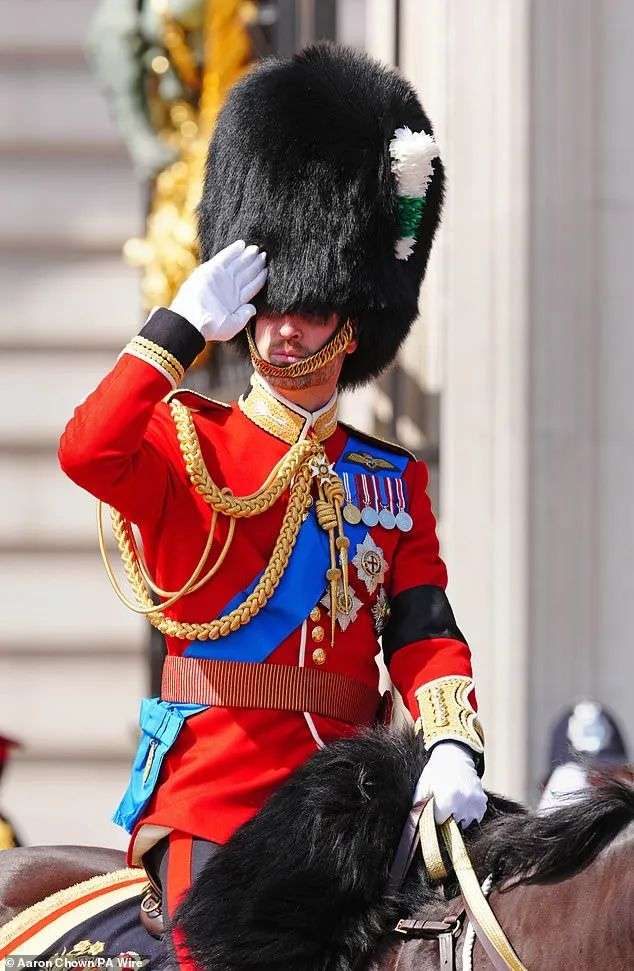 A barely recognisable Prince William salutes during the Trooping the Colour ceremony on London on Saturday, bearing a black armband in remembrance of all those who died during the Air India crash on Thursday, which took the lives of 52 Britons