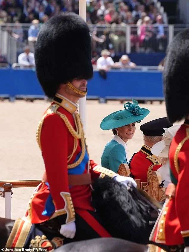 Princess Catherin eyes up her husband Prince William (left) as he performs his ceremonial role
