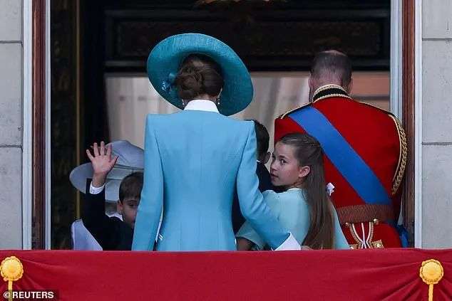 Prince Louis and Princess Charlotte turn back towards the crowds as they leave the balcony at Buckingham Palace