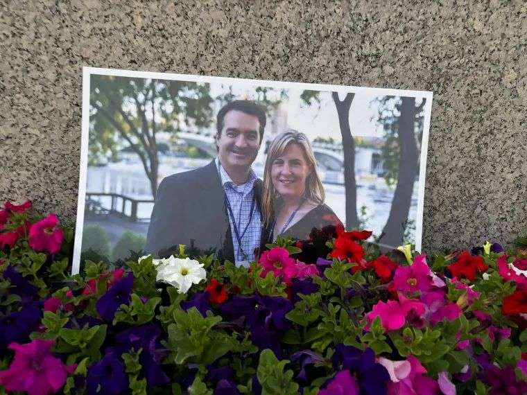 A photograph of Melissa Hortman and her husband amongst flowers