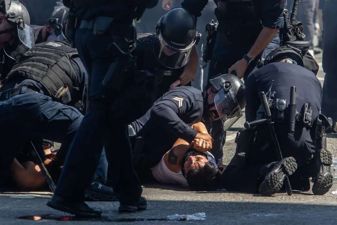 Los Angeles Police Department officers arrest a protester in front of the LA Federal Building on Sunday.