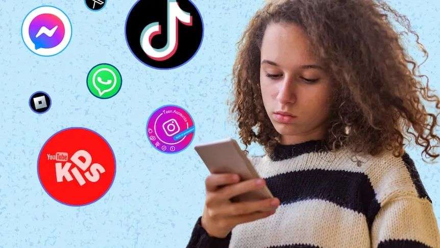 Teen girl with curly hair and tan skin looks down at her phone wearing a stripy jumper. There are social media icons next to her
