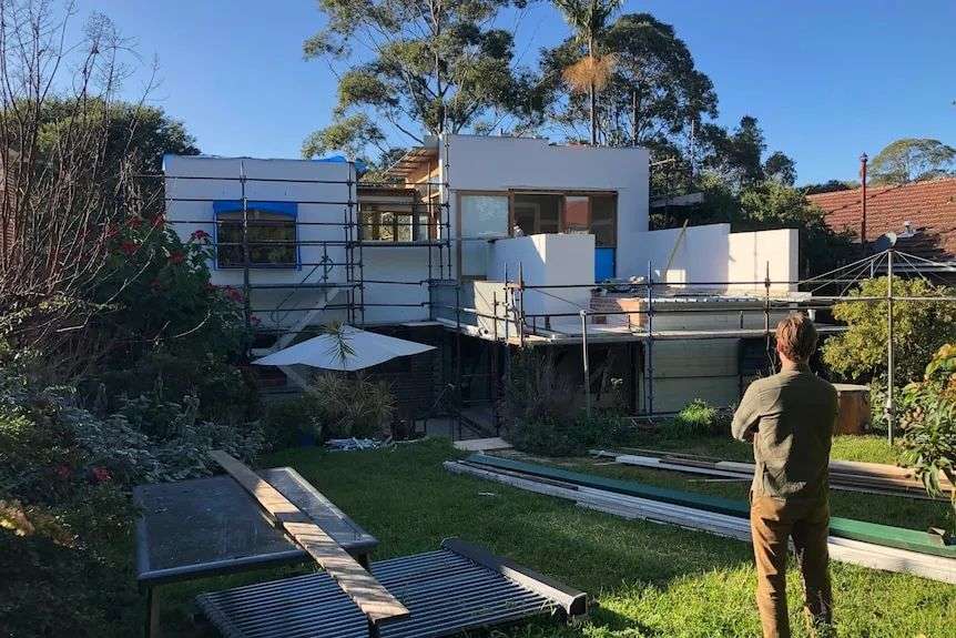 the second story of the house under construction surrounded by scaffolding