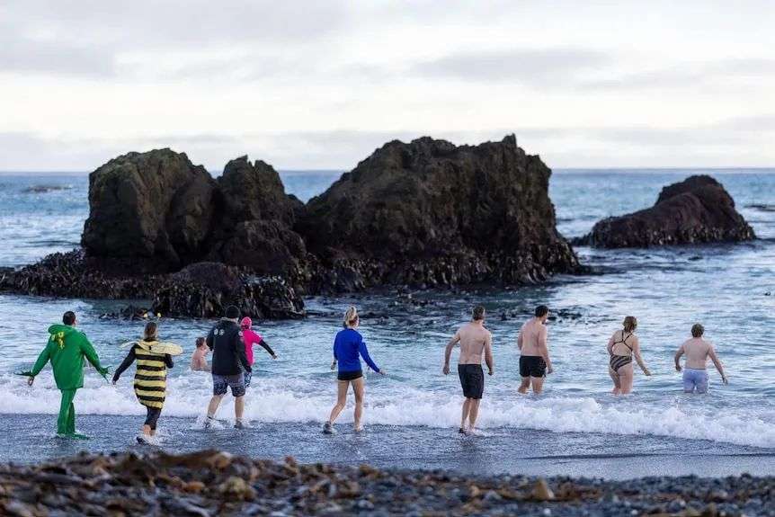 People running into the ocean.