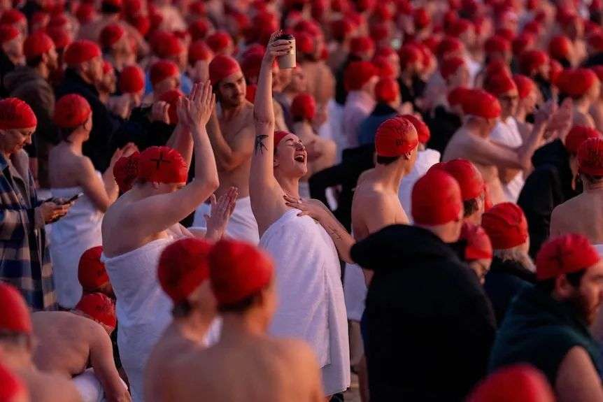 People celebrating the winter solstice swim.