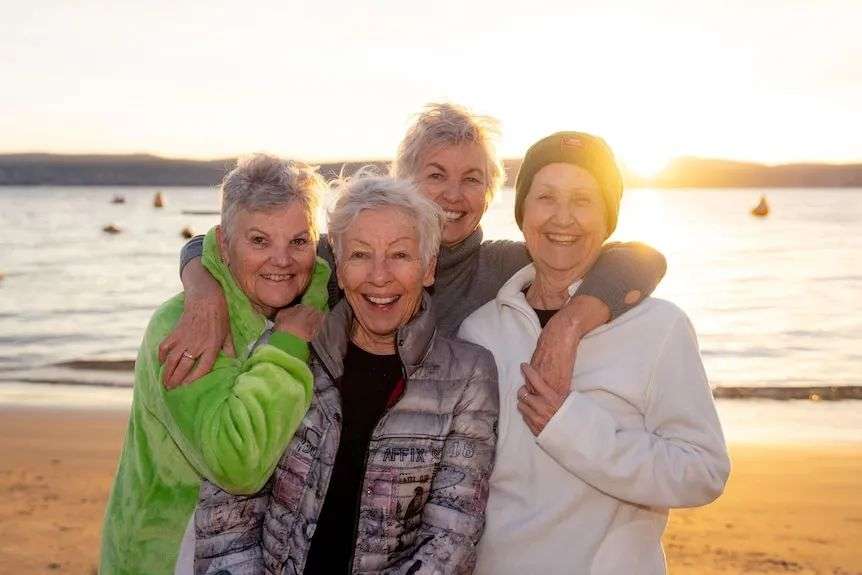 Four women hugging.