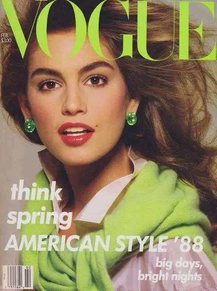A close up of supermodel Cindy Crawford on the cover of Vogue in a lime green sweater and red lipstick.