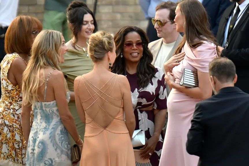 Oprah smiling in a crowd.