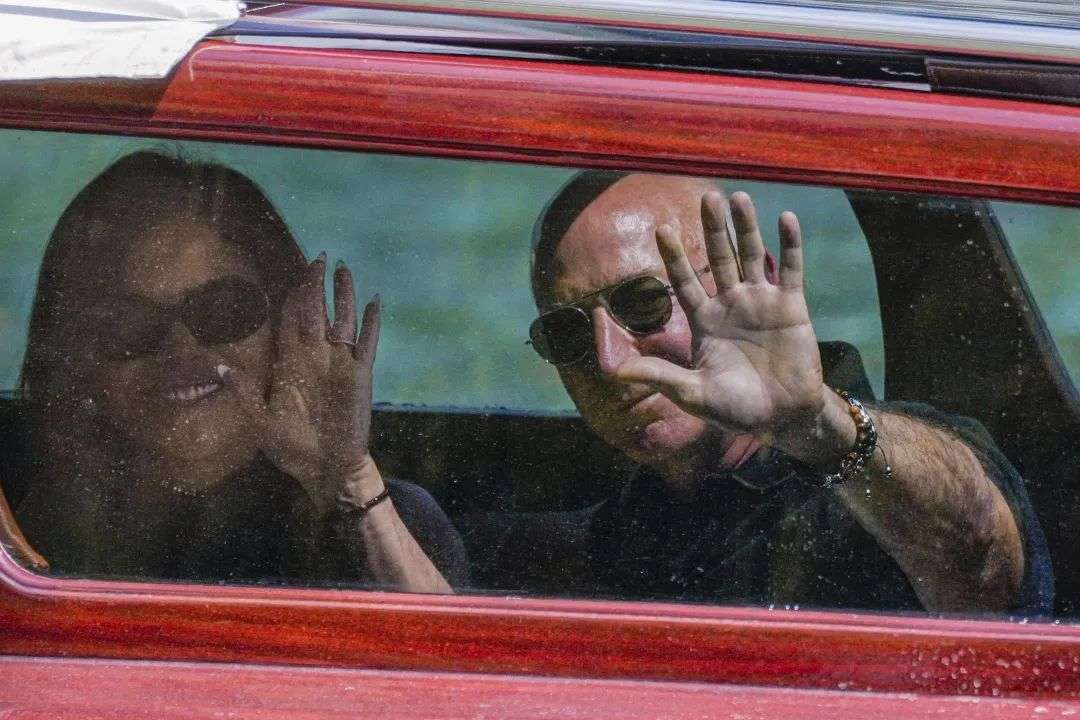 Sanchez and Bezos arrive by boat at a hotel in Venice on Wednesday, June 25.
