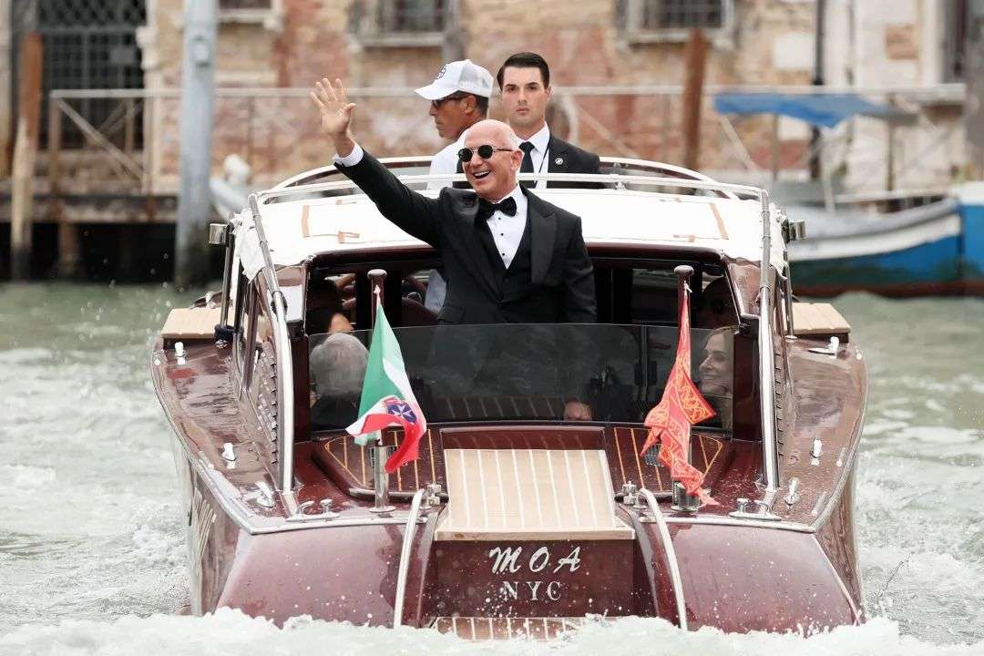 Bezos' boat travels on the Grand Canal as he departs for his wedding on Friday.