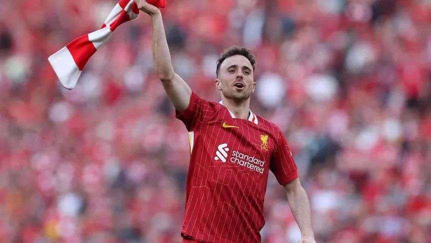 Liverpool's Diogo Jota celebrates after winning the Premier League waving a scarf