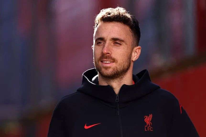 Close up of footballer in black jacket.