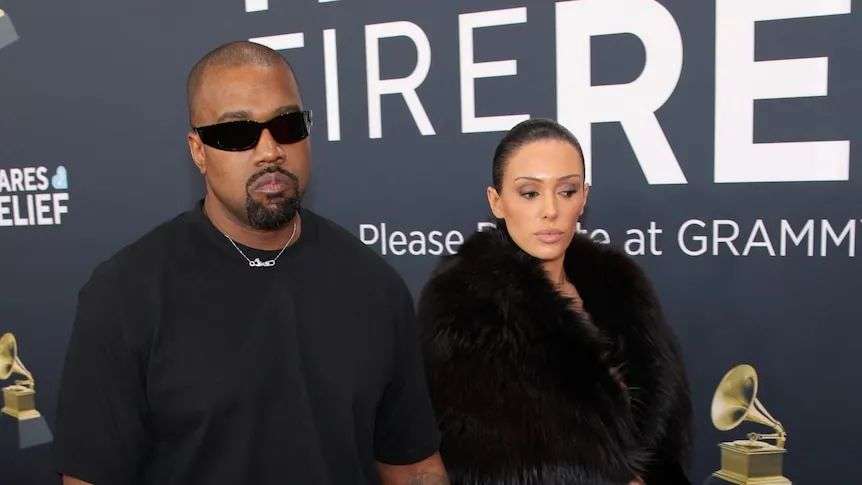 Ye wears a black tee and jeans, Censori wears a black fur coat