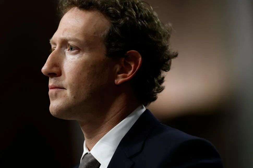 Side profile of man in black suit and tie