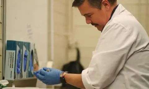 Prof Andrew Pask holding a dunnart