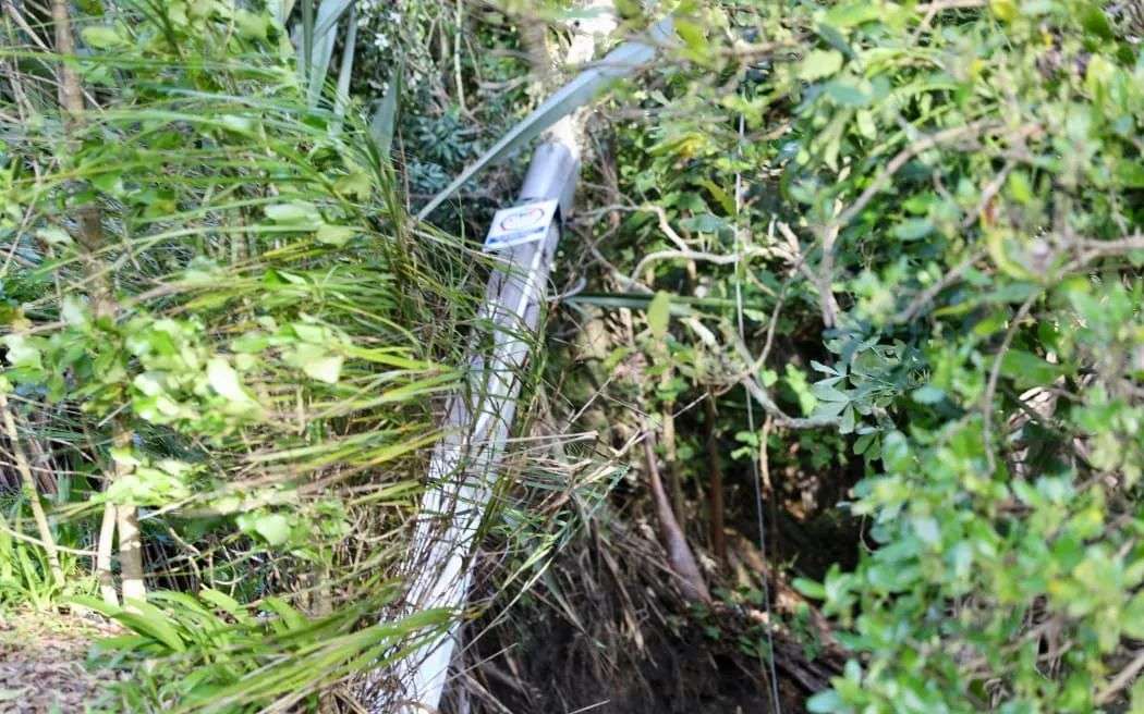 A power pole has come down with wires still attached.