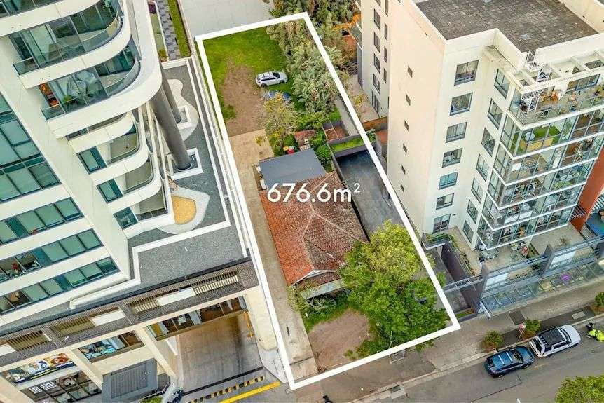 A birds eye view of the property surrounded by high rises, indicating the brick home is 676.6 metres squared in size.