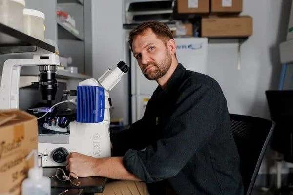 Lucas Dillard sits in a laboratory.