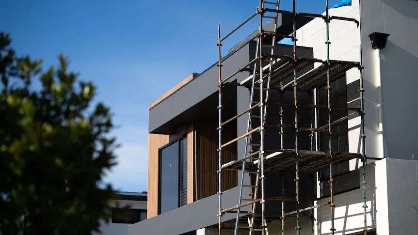 Houses under construction on a bright, sunny day