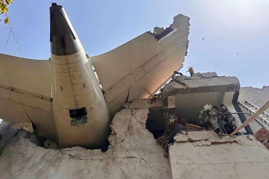 A plane tail crashed into the back of a building.