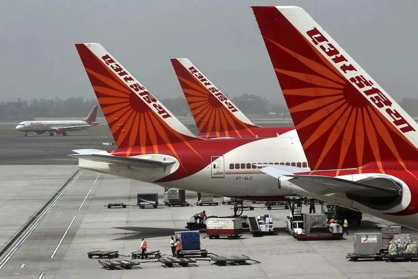 A row of Air India planes outside an airport