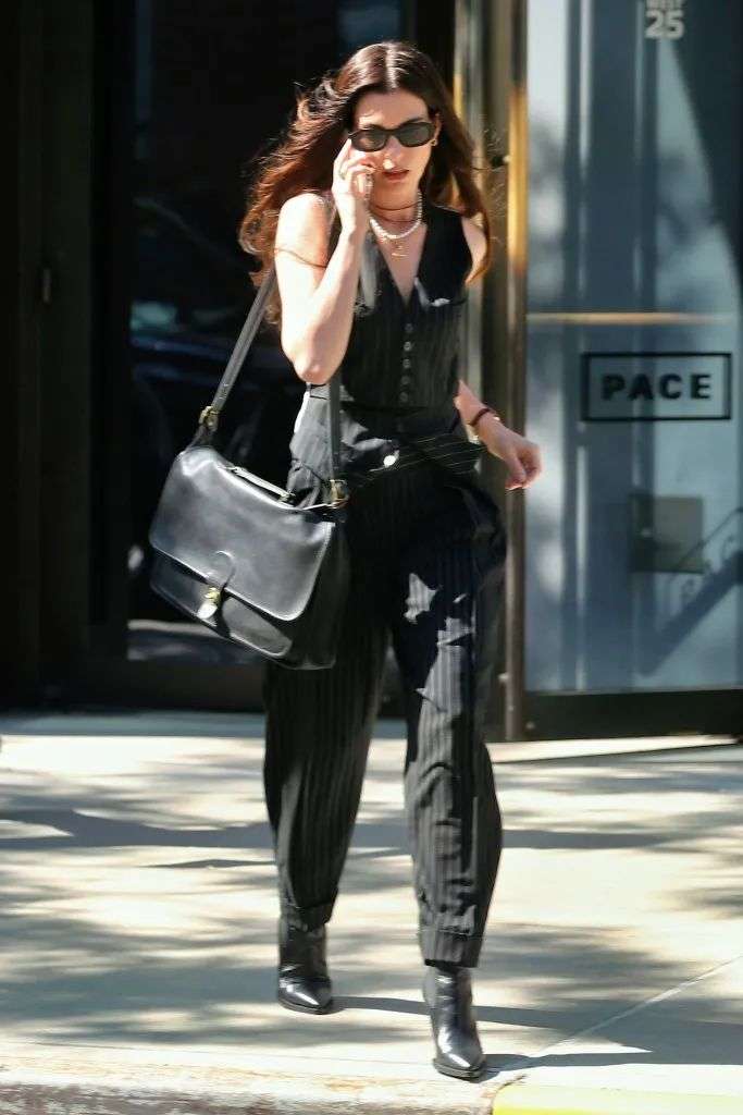 Anne Hathaway chats on her phone leaving Pace Gallery filming 'Devil Wears Prada 2' in New York City