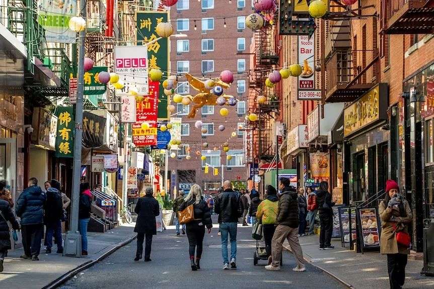 A narrow street filled with Chinese lanterns