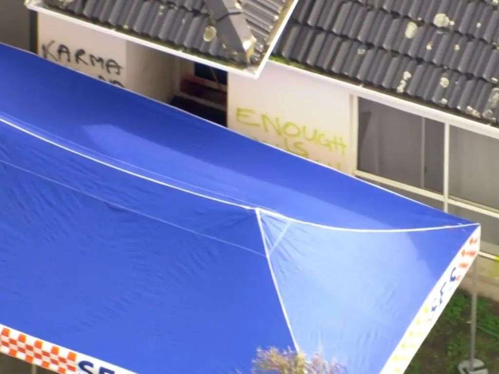 Graffiti could be seen sprayed in yellow and black paint on the side of the home. Picture: 7News