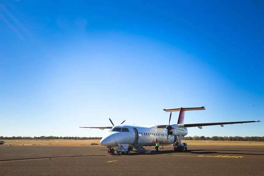A Qantaslink Dash 8 plane waits on an otherwise empty tarmac at Charleville airport, in Outback Queensland.