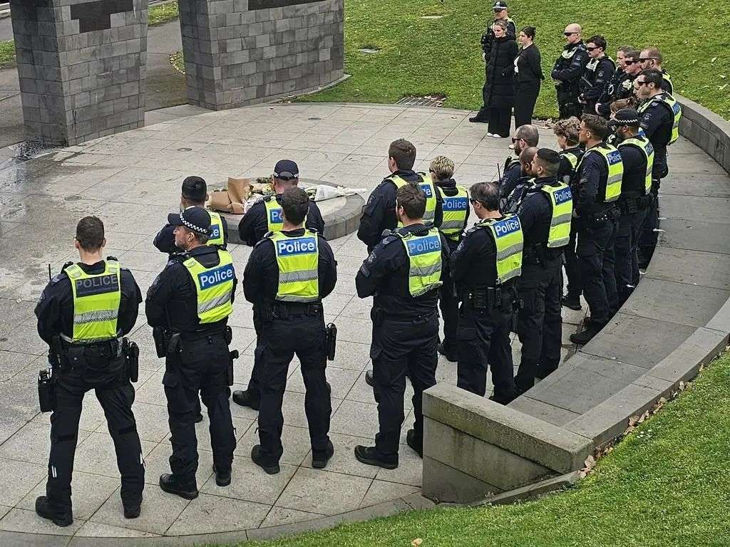 Members of the public and police are at the Police Memorial in Kings Domain on Wednesday morning. Picture: JORDAN MCCARTHY,