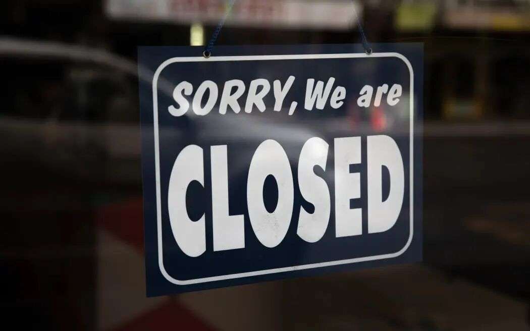 Sign that reads 'Sorry, We are closed' hanging in a shop front in Central Auckland during Lockdown Level 3.